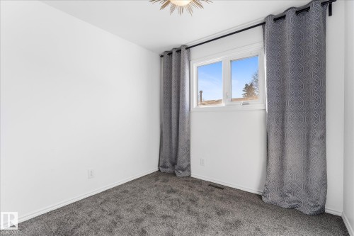 This room features light-colored walls and grey carpet flooring - 2626 49 Street, Edmonton, AB - Indoor Photo Showing Other Room
