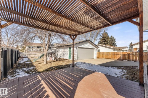 The property features a wooden deck with an overhead pergola structure, offering an inviting outdoor space - 2626 49 Street, Edmonton, AB - Outdoor With Deck Patio Veranda With Exterior