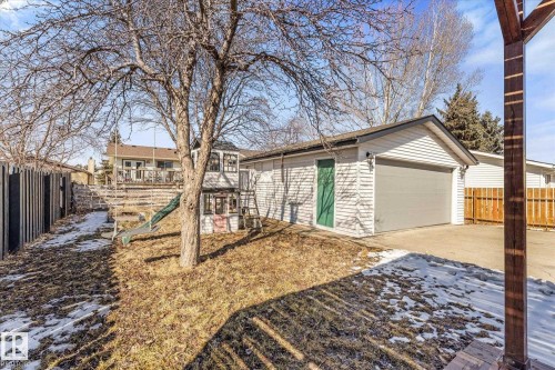 This property features a detached garage with a garage door and a separate entry door - 2626 49 Street, Edmonton, AB - Outdoor