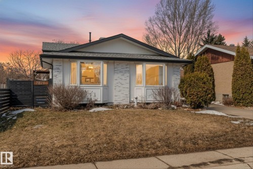 The property features a white brick exterior and a dark roof - 2626 49 Street, Edmonton, AB - Outdoor