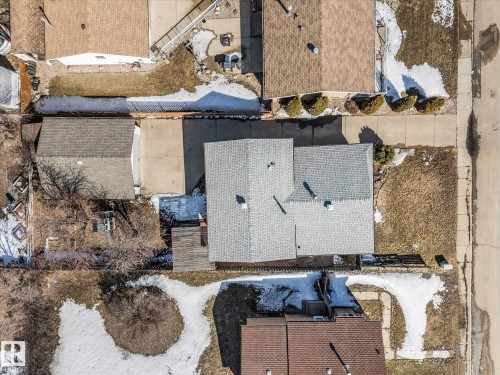 Aerial view of the property, showcasing a gray-shingled roof, a paved driveway, and surrounding grounds with natural landscaping - 2626 49 Street, Edmonton, AB - Outdoor With Deck Patio Veranda