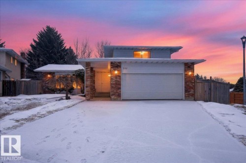 The property features a front-facing garage, a brick facade, and an entryway with overhead lighting - 391 Lee Ridge Road, Edmonton, AB - Outdoor