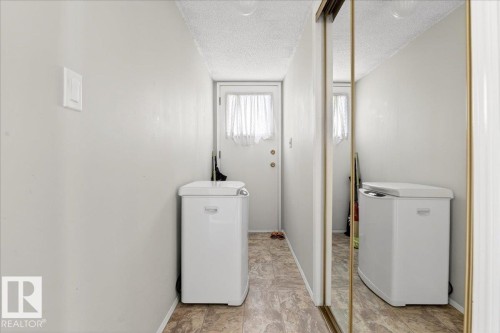 Utility area featuring light-colored walls, a textured ceiling, and a white door with a window - 391 Lee Ridge Road, Edmonton, AB - Indoor Photo Showing Laundry Room