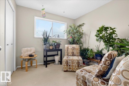 This inviting room features a window with horizontal blinds, neutral-toned walls, and carpet flooring - 391 Lee Ridge Road, Edmonton, AB - Indoor Photo Showing Other Room
