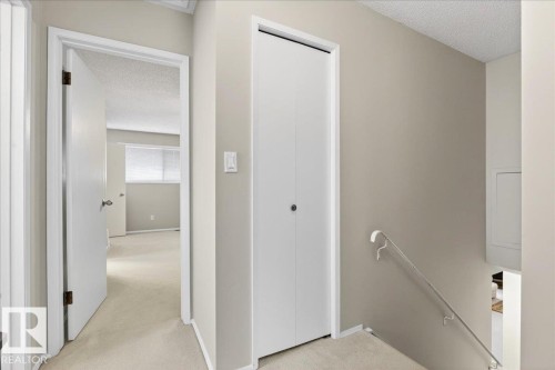 The property features a hallway with light-colored carpeting, neutral-toned walls, and white trim - 391 Lee Ridge Road, Edmonton, AB - Indoor Photo Showing Other Room