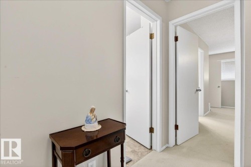 The property features light-colored walls and carpeted flooring in the hallway - 391 Lee Ridge Road, Edmonton, AB - Indoor Photo Showing Other Room