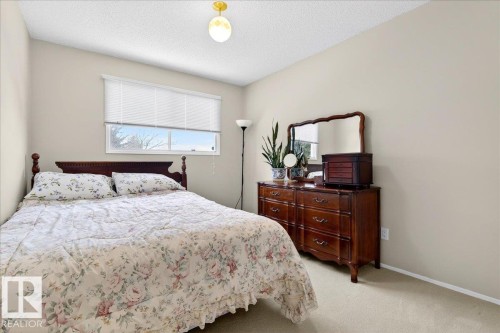 This room features light-colored walls and carpeting, with a window providing natural light - 391 Lee Ridge Road, Edmonton, AB - Indoor Photo Showing Bedroom