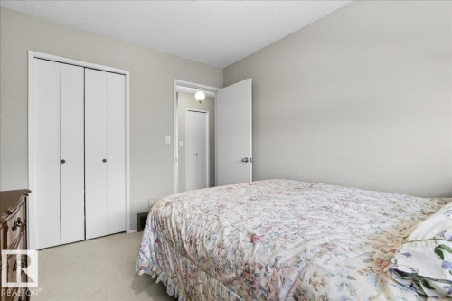 This room features light-colored walls and carpeting, with white bi-fold closet doors - 391 Lee Ridge Road, Edmonton, AB - Indoor Photo Showing Bedroom