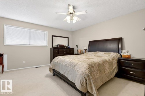 The bedroom features a window with blinds, carpeted flooring, and a ceiling fan - 391 Lee Ridge Road, Edmonton, AB - Indoor Photo Showing Bedroom