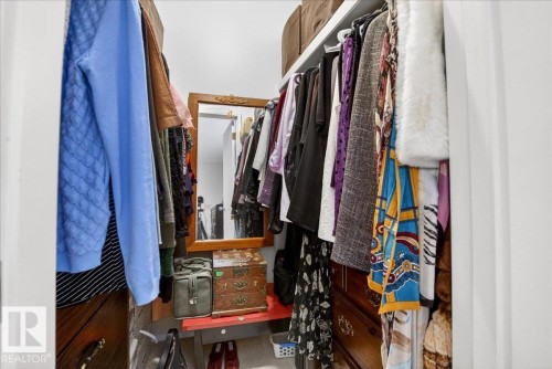 The property features a walk-in closet with built-in shelving, a full-length mirror, and ample storage space - 391 Lee Ridge Road, Edmonton, AB - Indoor With Storage