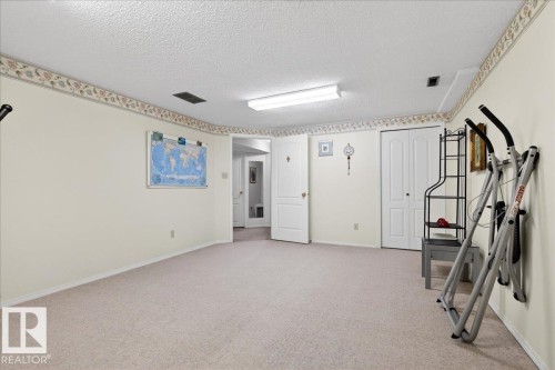 Spacious room featuring light-colored carpet flooring and white walls with decorative trim - 391 Lee Ridge Road, Edmonton, AB - Indoor Photo Showing Other Room