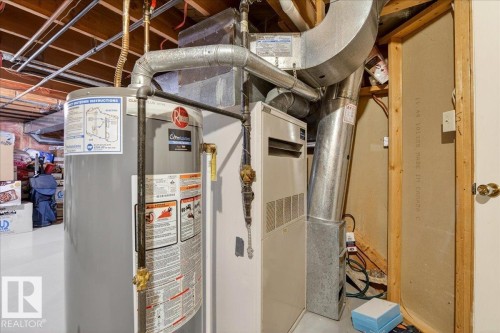 Utility area featuring a water heater, furnace, and exposed overhead ductwork - 391 Lee Ridge Road, Edmonton, AB - Indoor Photo Showing Basement