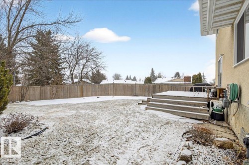 The property features a fenced yard, a wooden deck with steps, and a stucco exterior - 391 Lee Ridge Road, Edmonton, AB - Outdoor