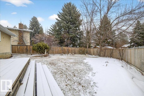 The property features a spacious backyard with a wooden fence and a deck - 391 Lee Ridge Road, Edmonton, AB - Outdoor