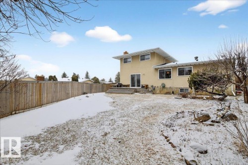 The property features a spacious backyard with a wooden fence and a multi-level deck - 391 Lee Ridge Road, Edmonton, AB - Outdoor