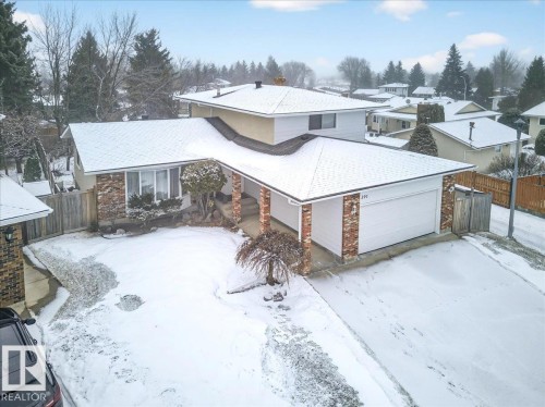 The property features a ranch-style home with an attached garage, a brick and siding exterior, and a paved driveway - 391 Lee Ridge Road, Edmonton, AB - Outdoor