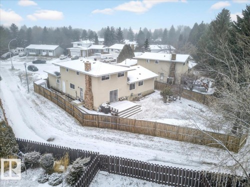 The property features a spacious backyard with a wooden fence and a multi-level deck - 391 Lee Ridge Road, Edmonton, AB - Outdoor