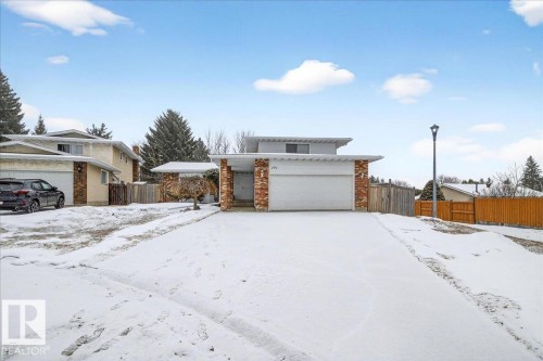 The property features a front-facing garage, a paved driveway, and brick accents on the facade - 391 Lee Ridge Road, Edmonton, AB - Outdoor
