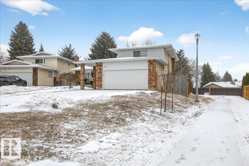 The property features a front-facing garage, a brick and stucco exterior, and a paved driveway - 391 Lee Ridge Road, Edmonton, AB - Outdoor