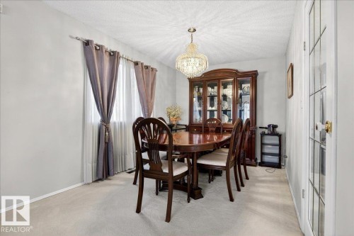 The property features a dining space with light-colored walls and a textured ceiling - 391 Lee Ridge Road, Edmonton, AB - Indoor Photo Showing Dining Room