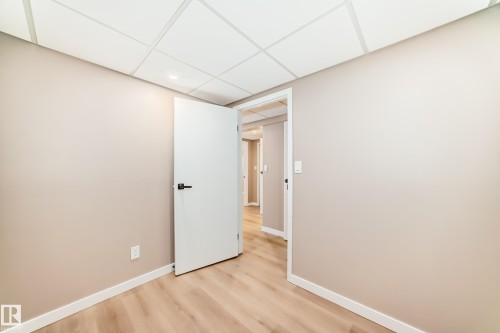 This room features light wood flooring, neutral tone walls, and a white ceiling with recessed lighting - 287 Lago Lindo Crescent, Edmonton, AB - Indoor Photo Showing Other Room