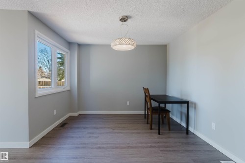 This room features light grey walls, white trim, and wood-look flooring - 17308 61 Avenue, Edmonton, AB - Indoor