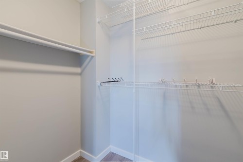 This closet features white wire shelving and hanging rods - 17308 61 Avenue, Edmonton, AB - Indoor With Storage