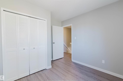 The property features light gray walls, a white door, and light-colored flooring - 17308 61 Avenue, Edmonton, AB - Indoor Photo Showing Other Room