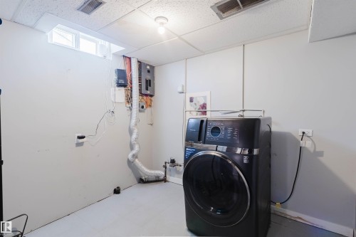The utility room features light-colored walls and a window - 17308 61 Avenue, Edmonton, AB - Indoor Photo Showing Laundry Room