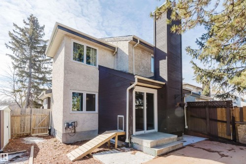 The property features an exterior with stucco and wood paneling, a concrete patio, and a privacy fence - 17308 61 Avenue, Edmonton, AB - Outdoor With Exterior