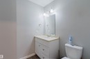 Bathroom featuring a white vanity with drawers, a light-colored countertop, and a mirror with overhead lighting - 17308 61 Avenue, Edmonton, AB  - Indoor Photo Showing Bathroom 