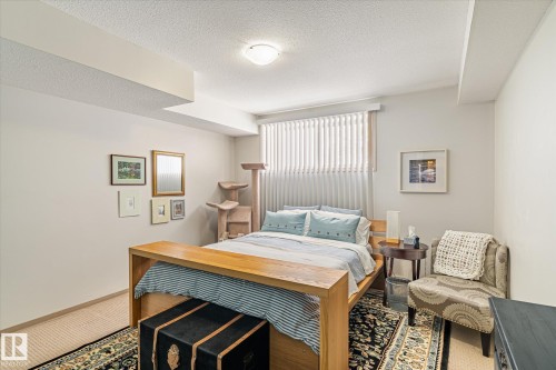 This room features neutral-toned walls, a window with vertical blinds, and a ceiling light fixture - 5 4902B 43 Street, Legal, AB 