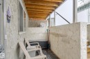 The property features an outdoor patio area with textured stucco walls and exposed wood beams on the ceiling - 5 4902B 43 Street, Legal, AB 