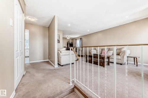 Inviting living area featuring light-colored carpeting and neutral wall tones, providing an airy atmosphere - 11323 162 Avenue, Edmonton, AB - Indoor Photo Showing Other Room