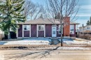 The property features a dark-colored exterior with white trim, a shingled roof, and a prominent brick chimney - 11323 162 Avenue, Edmonton, AB  - Outdoor 