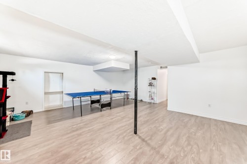 This spacious room features light-toned flooring, white walls, and a ceiling with recessed lighting - 11323 162 Avenue, Edmonton, AB - Indoor Photo Showing Other Room