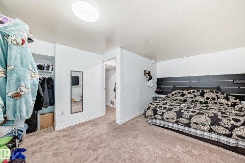 The room features neutral carpet flooring and white walls, with a built-in closet visible - 11323 162 Avenue, Edmonton, AB - Indoor