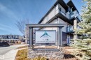 The property features modern exterior architecture with light-colored siding and dark trim, accented by stone detailing - 11 1530 Tamarack Boulevard, Edmonton, AB  - Outdoor With Balcony 