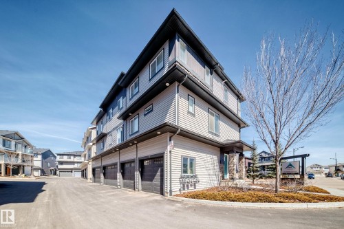 The property features a modern exterior with horizontal siding and multiple windows - 11 1530 Tamarack Boulevard, Edmonton, AB - Outdoor
