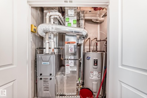 Utility closet housing the property's furnace and water heater - 11 1530 Tamarack Boulevard, Edmonton, AB - Indoor Photo Showing Basement