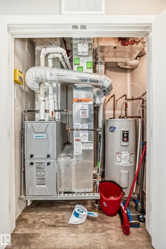 The property includes a water heater and furnace, installed within a utility closet - 11 1530 Tamarack Boulevard, Edmonton, AB - Indoor Photo Showing Basement
