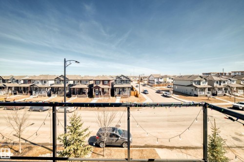 View showcasing the neighborhood with a residential street and homes featuring multiple architectural styles - 11 1530 Tamarack Boulevard, Edmonton, AB - Outdoor With View