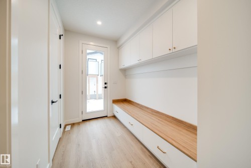 Entryway featuring light-colored flooring, white walls, and a glass-paneled door - 9536 148 Street, Edmonton, AB - Indoor Photo Showing Other Room