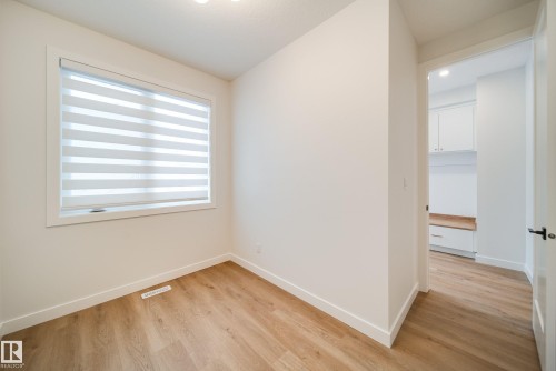 This property features light-toned flooring and white walls, creating a bright and airy atmosphere - 9536 148 Street, Edmonton, AB - Indoor Photo Showing Other Room