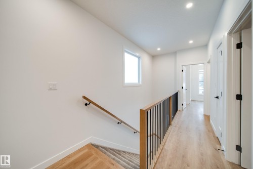 Hallway with light wood flooring, white walls, recessed lighting, and a window providing natural light - 9536 148 Street, Edmonton, AB - Indoor Photo Showing Other Room