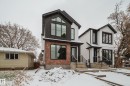 The property features a modern exterior design with a black roof, white siding, and brick accents - 9536 148 Street, Edmonton, AB  - Outdoor With Facade 