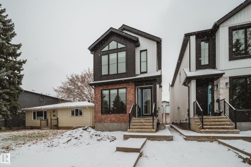 The property features a contemporary exterior with black siding and brick accents - 9536 148 Street, Edmonton, AB - Outdoor With Facade