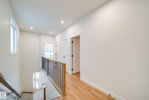 The property features light wood flooring, white walls, and recessed lighting - 9536 148 Street, Edmonton, AB - Indoor Photo Showing Other Room