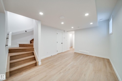 This expansive room features light-toned flooring, white walls, and recessed lighting - 9536 148 Street, Edmonton, AB - Indoor Photo Showing Other Room