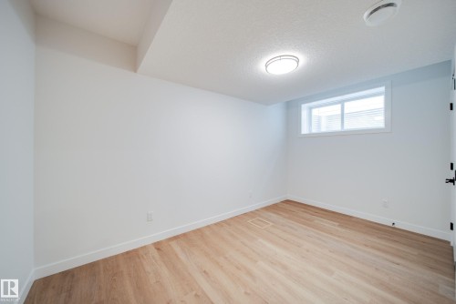 This room features light-toned flooring, white walls, and a window with blinds - 9536 148 Street, Edmonton, AB - Indoor Photo Showing Other Room